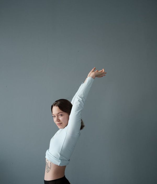 Athlete stretching in a calm, focused environment with soft lighting.